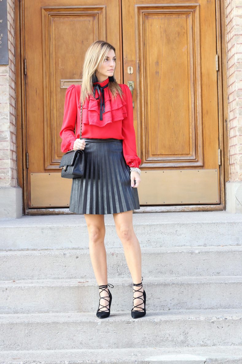 red frilled blouse with pleated faux-leather skirt mandy furnis