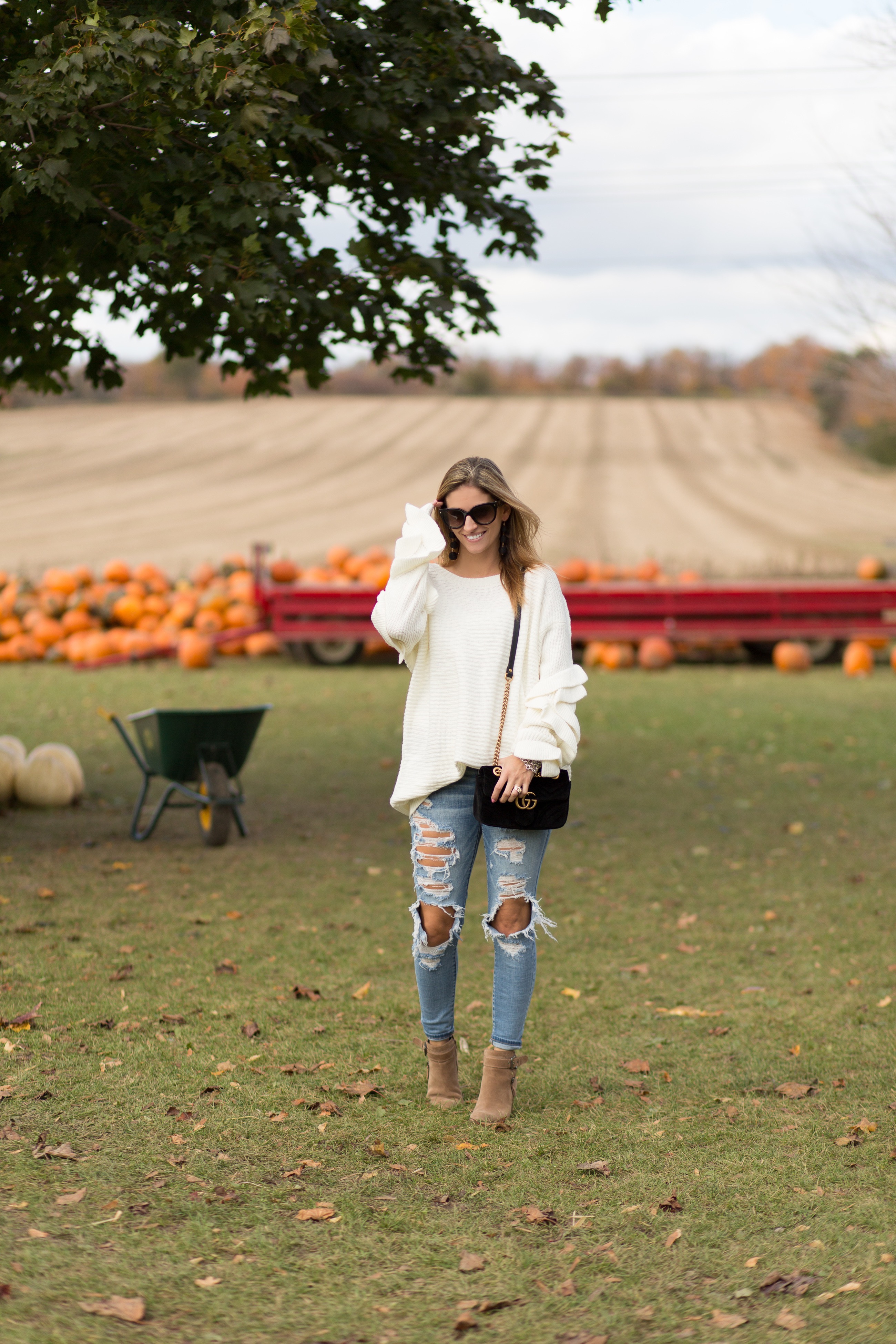 distressed jeans with oversized white sweater