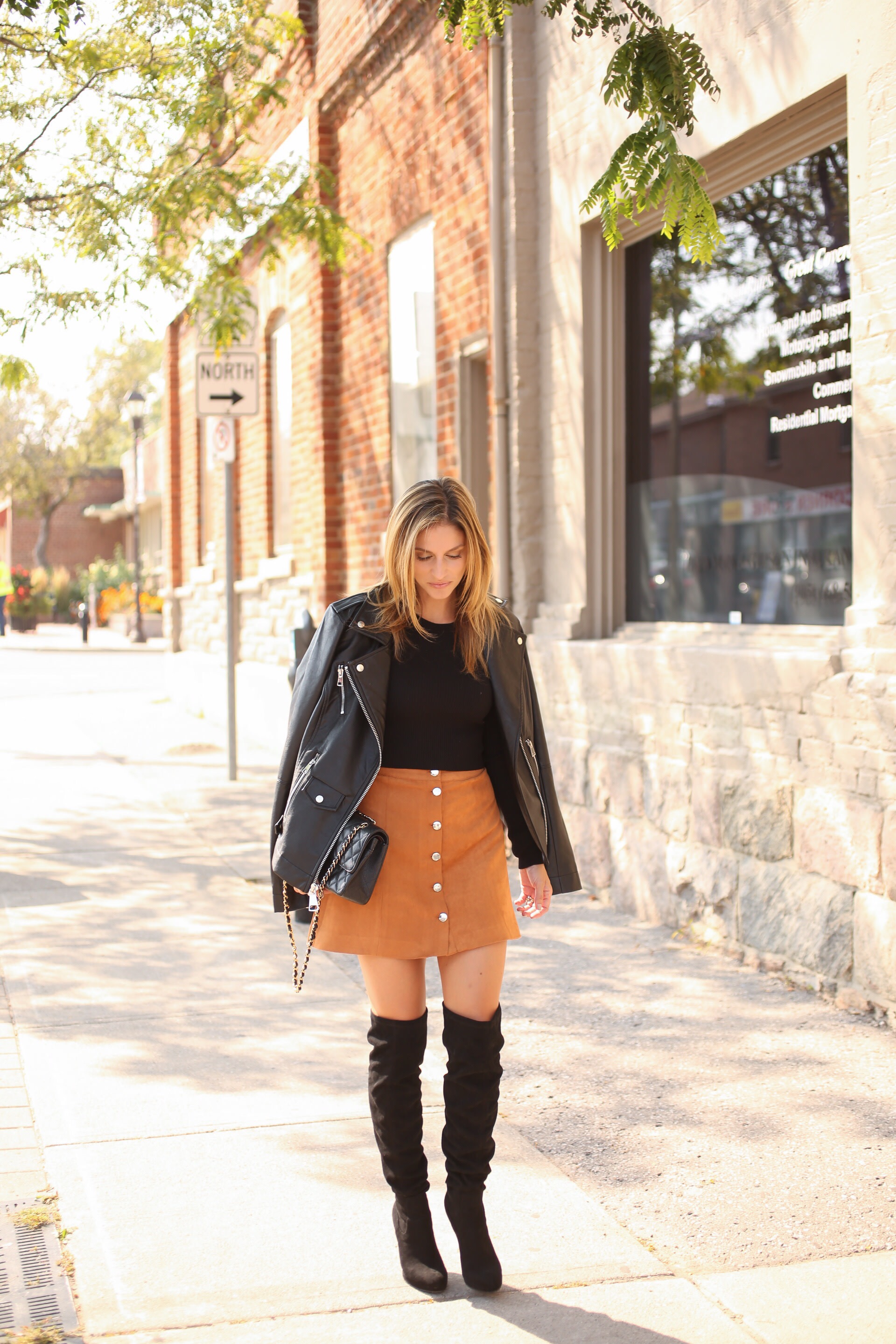 Button down suede skirt, black sweater, leather jacket, black over the knee boots