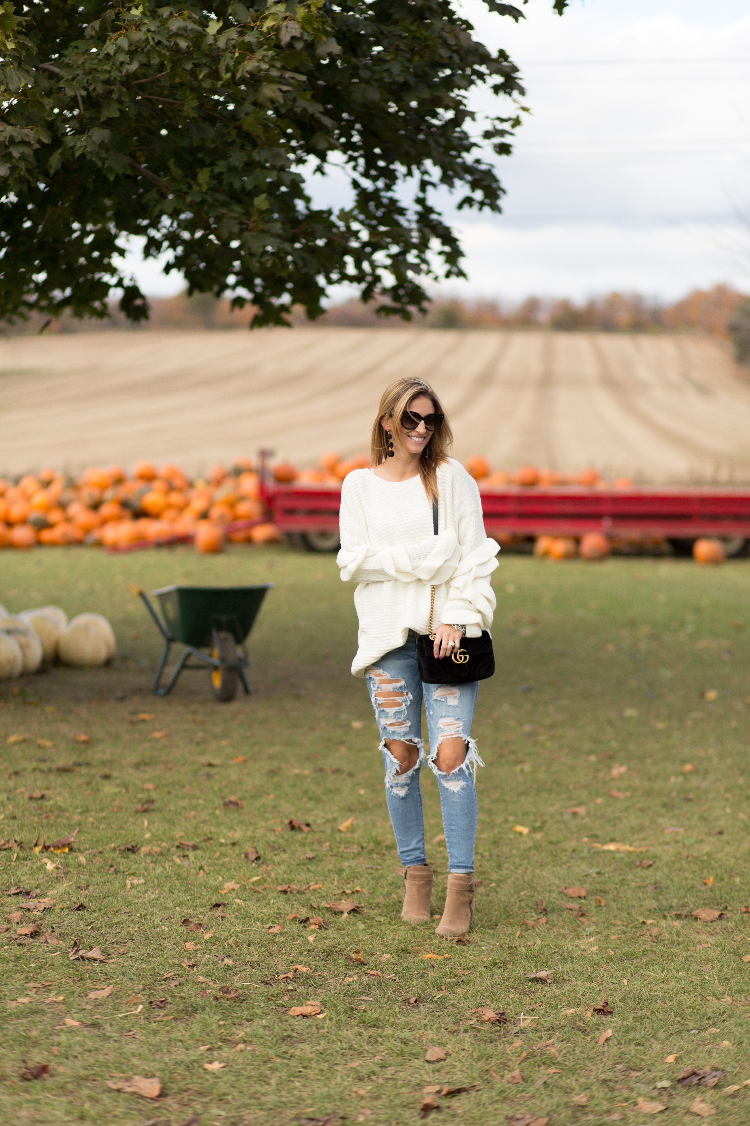 White oversized sweater with ripped jeans