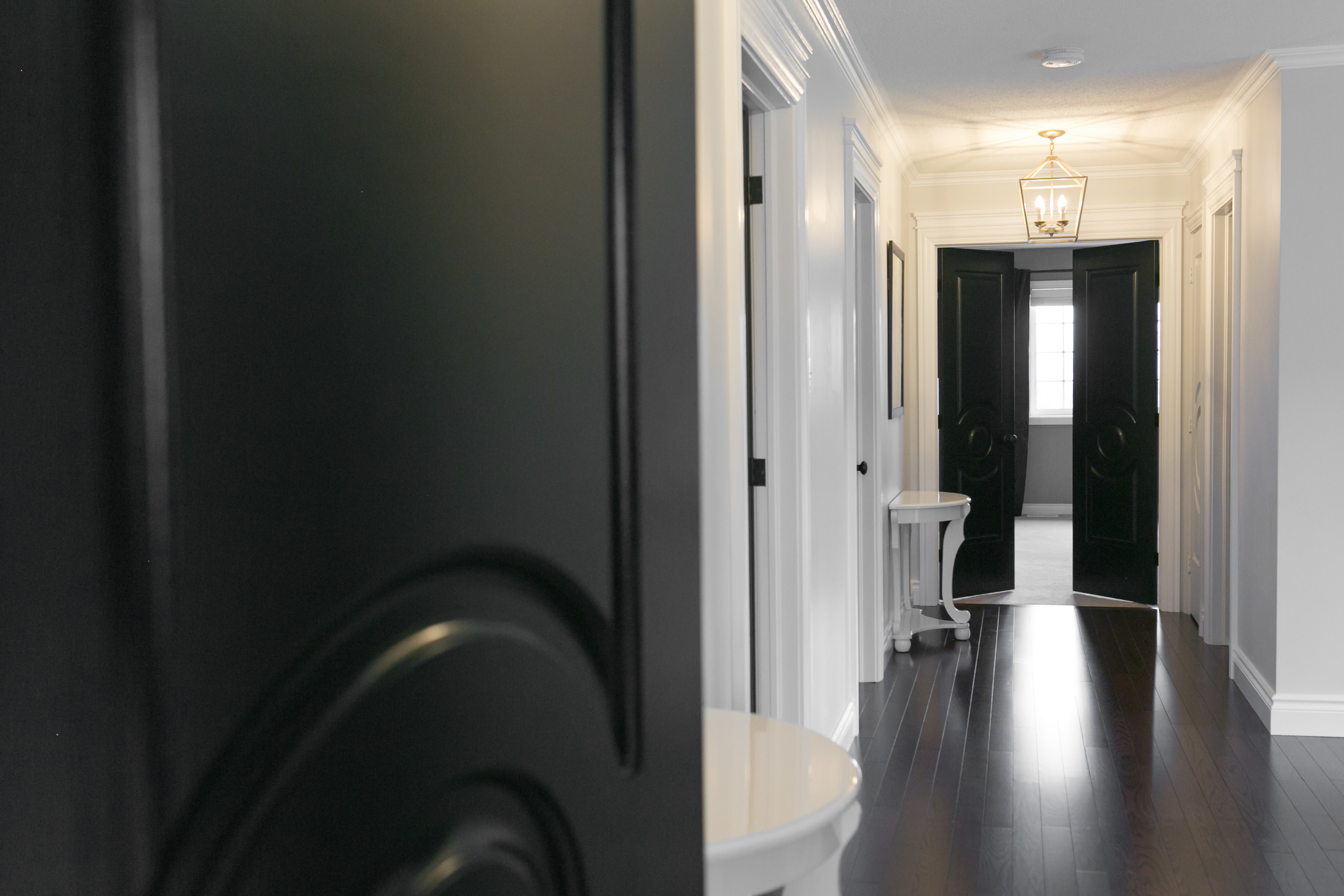 white hallway with black doors sparkleshinylove metrie