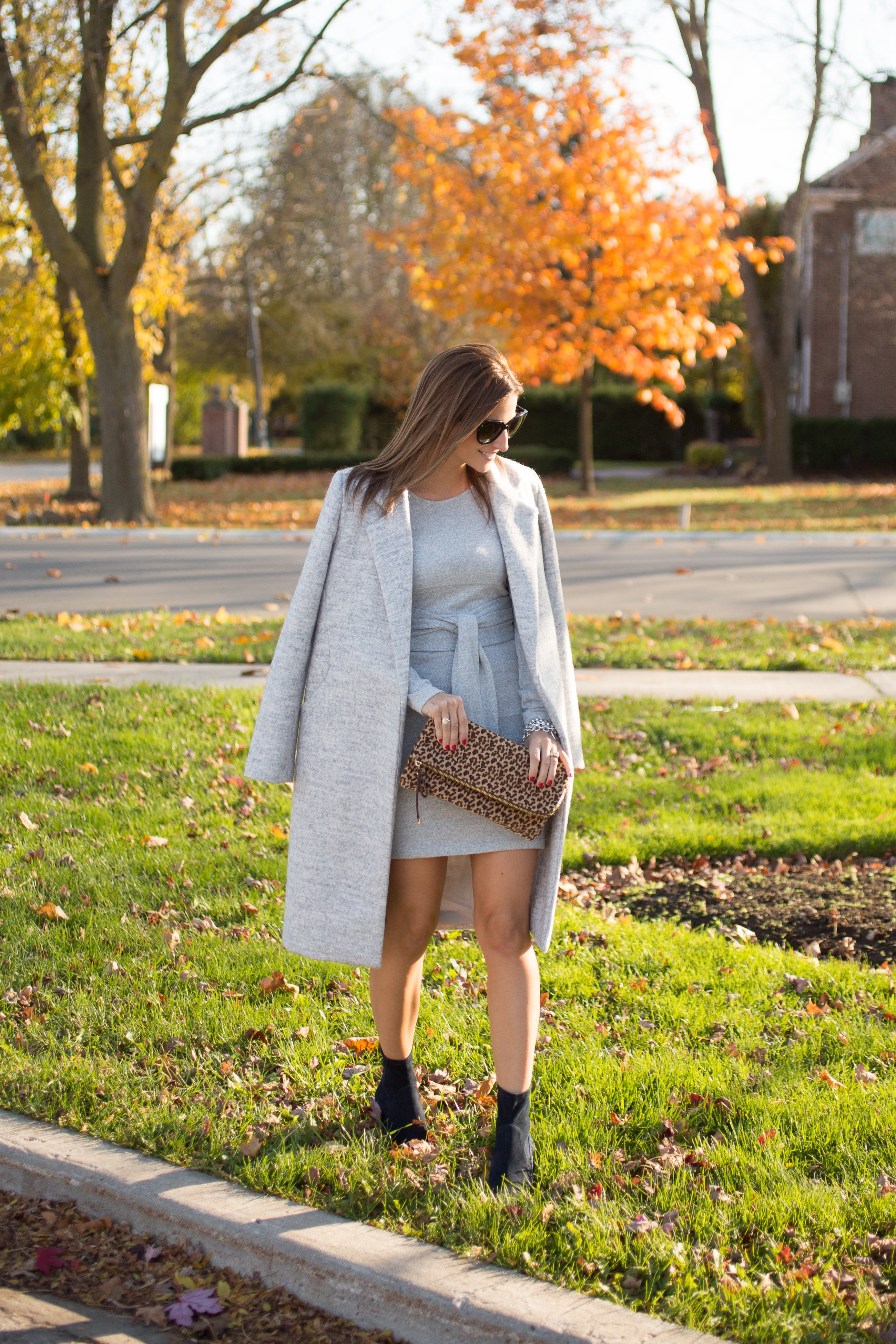 Fall look with a grey sweater dress from Dynamite, long grey coat, and leopard clutch.  Pointed toe black sock boots from Call it spring