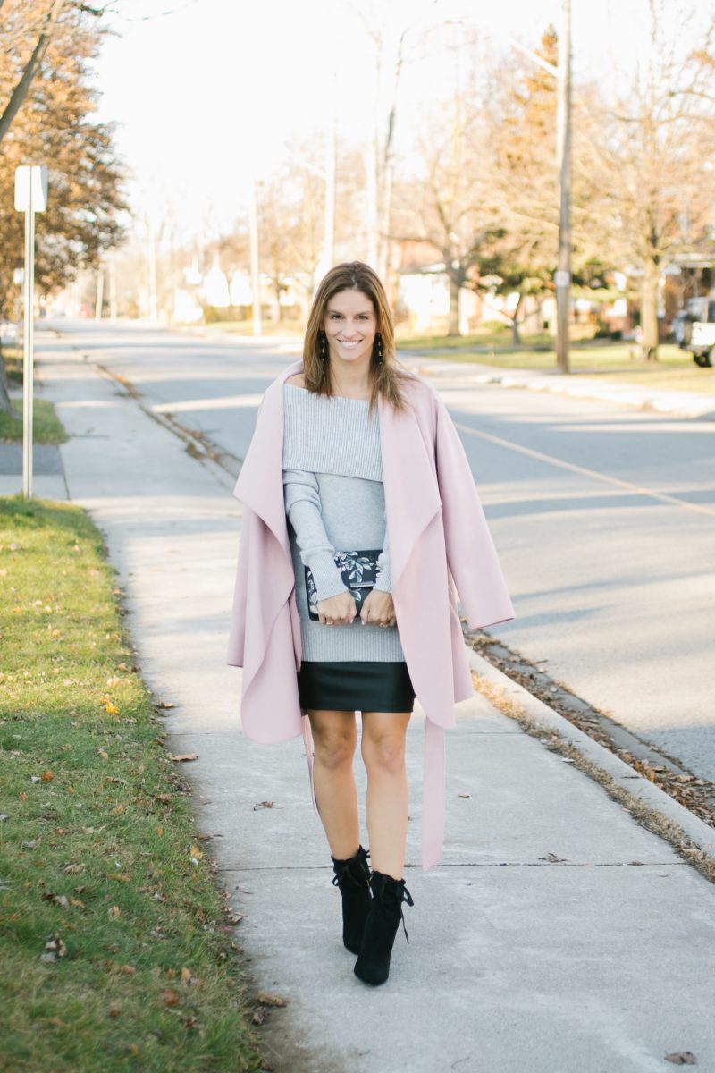 Pink wrap coat; grey off the shoulder lace up sweater, leather skirt, floral clutch and suede booties le chateau