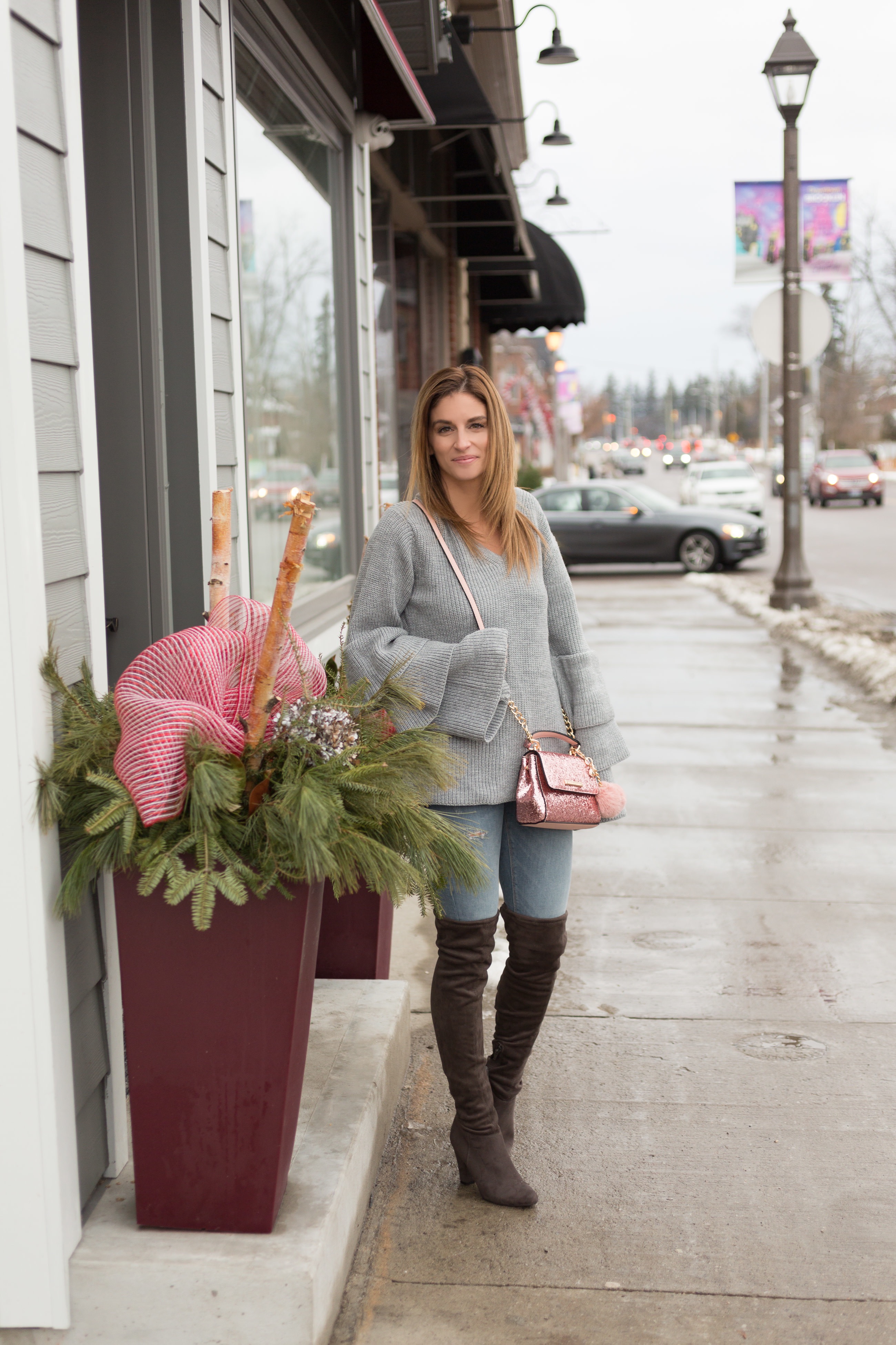 Grey ruffle sleeve sweater, pink poppy & peonies purse with sequins and pompoms, zara jeans, grey over the knee boots mandy furnis sparkleshinylove