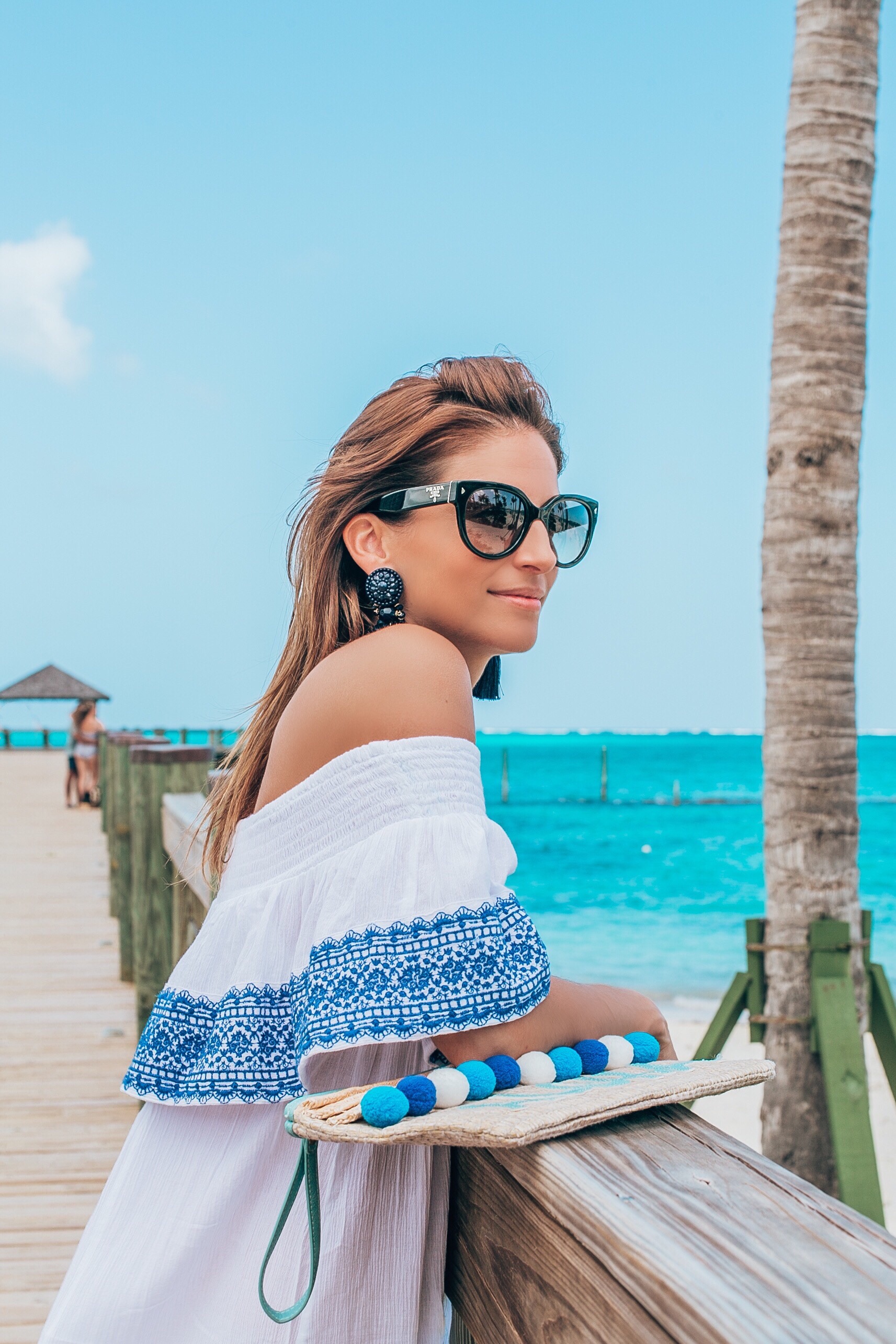 Perfect white and blue off the shoulder dress with valentino rockstud flip flops and Aloha pom pom bag; baha mar resort Bahamas; mandy furnis sparkleshinylove