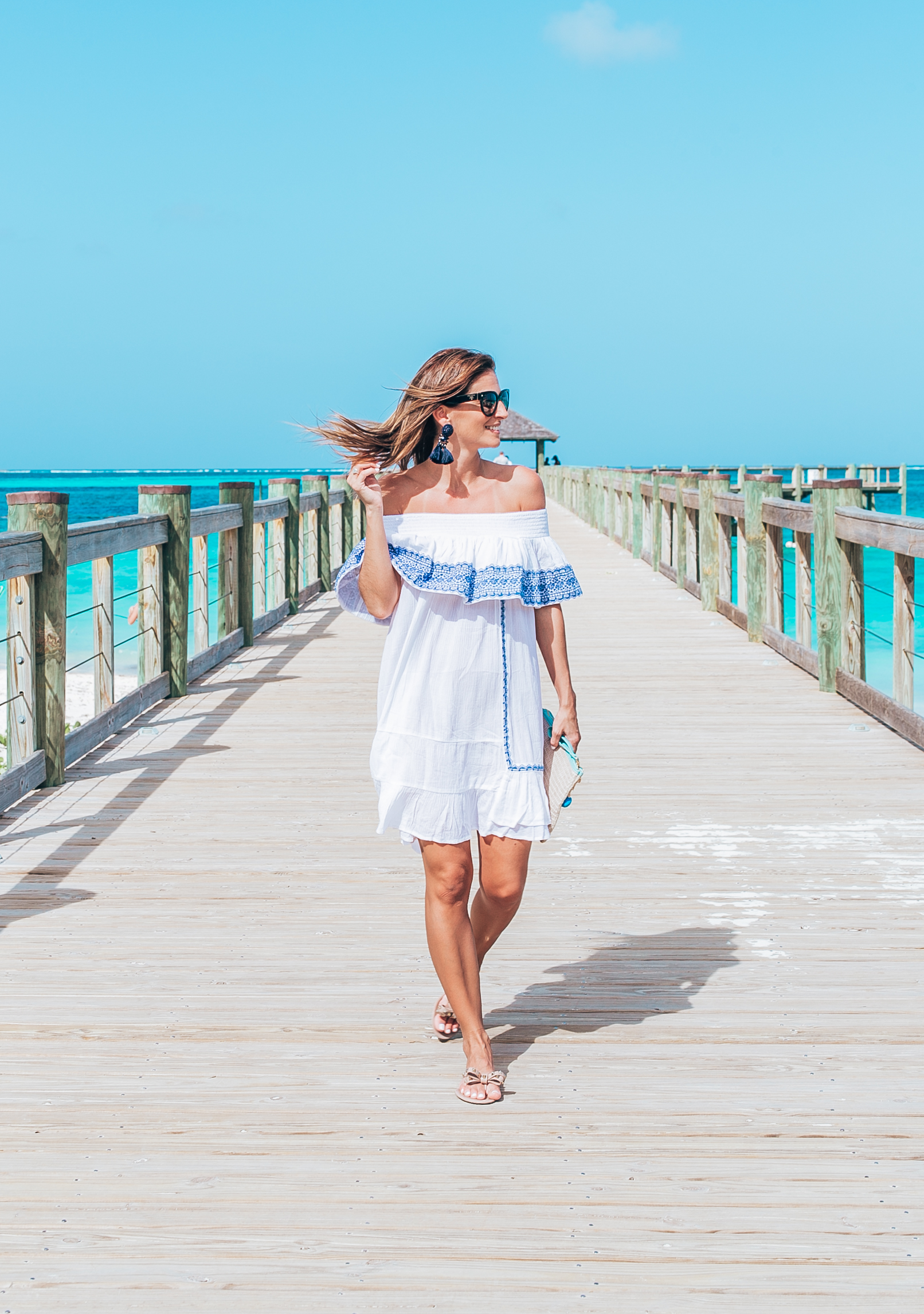 Perfect white and blue off the shoulder dress with valentino rockstud flip flops and Aloha pom pom bag; baha mar resort Bahamas; mandy furnis sparkleshinylove