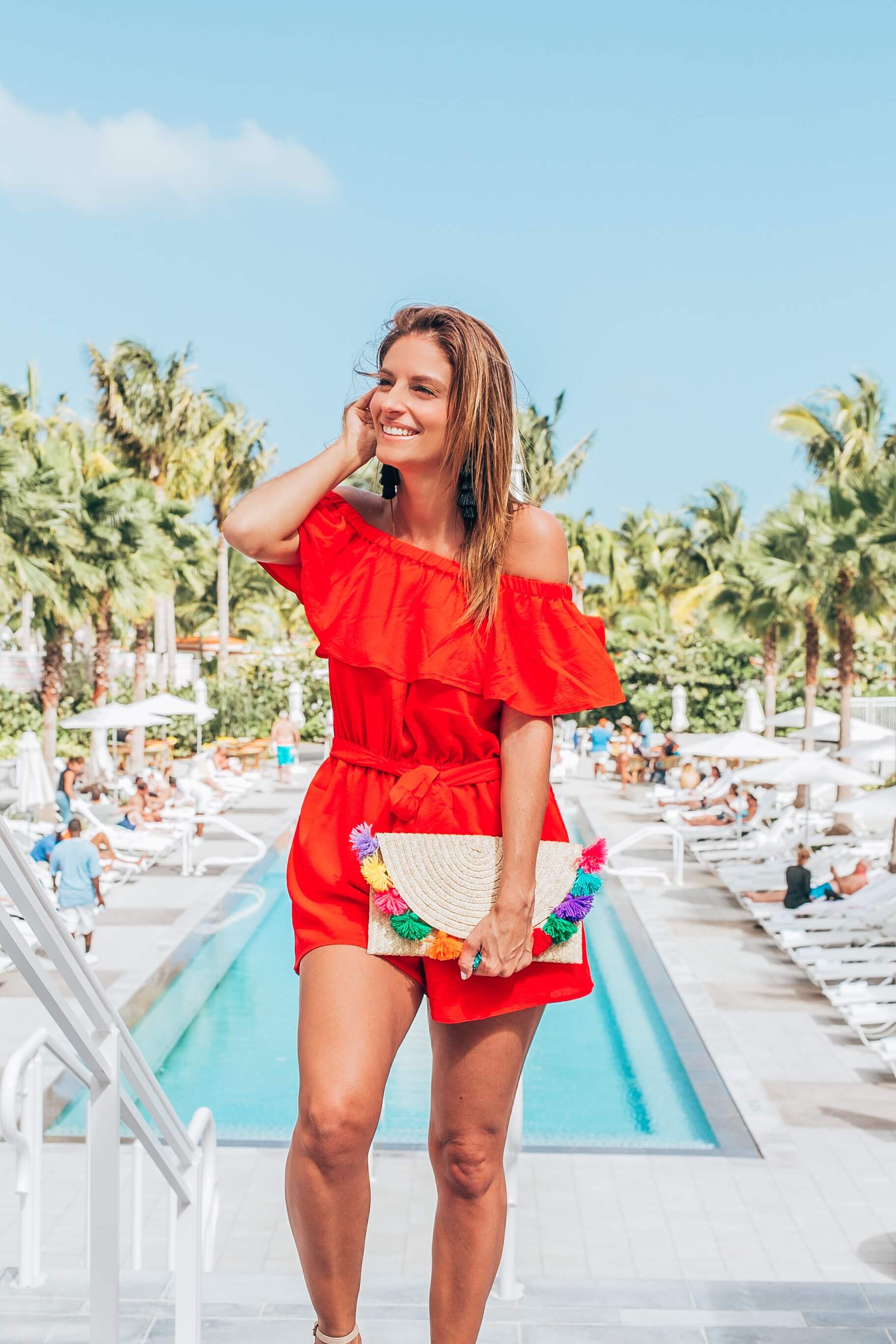 Red romper for summer with tassel clutch and espadrilles what to wear on vacation sparkleshinylove mandy furnis