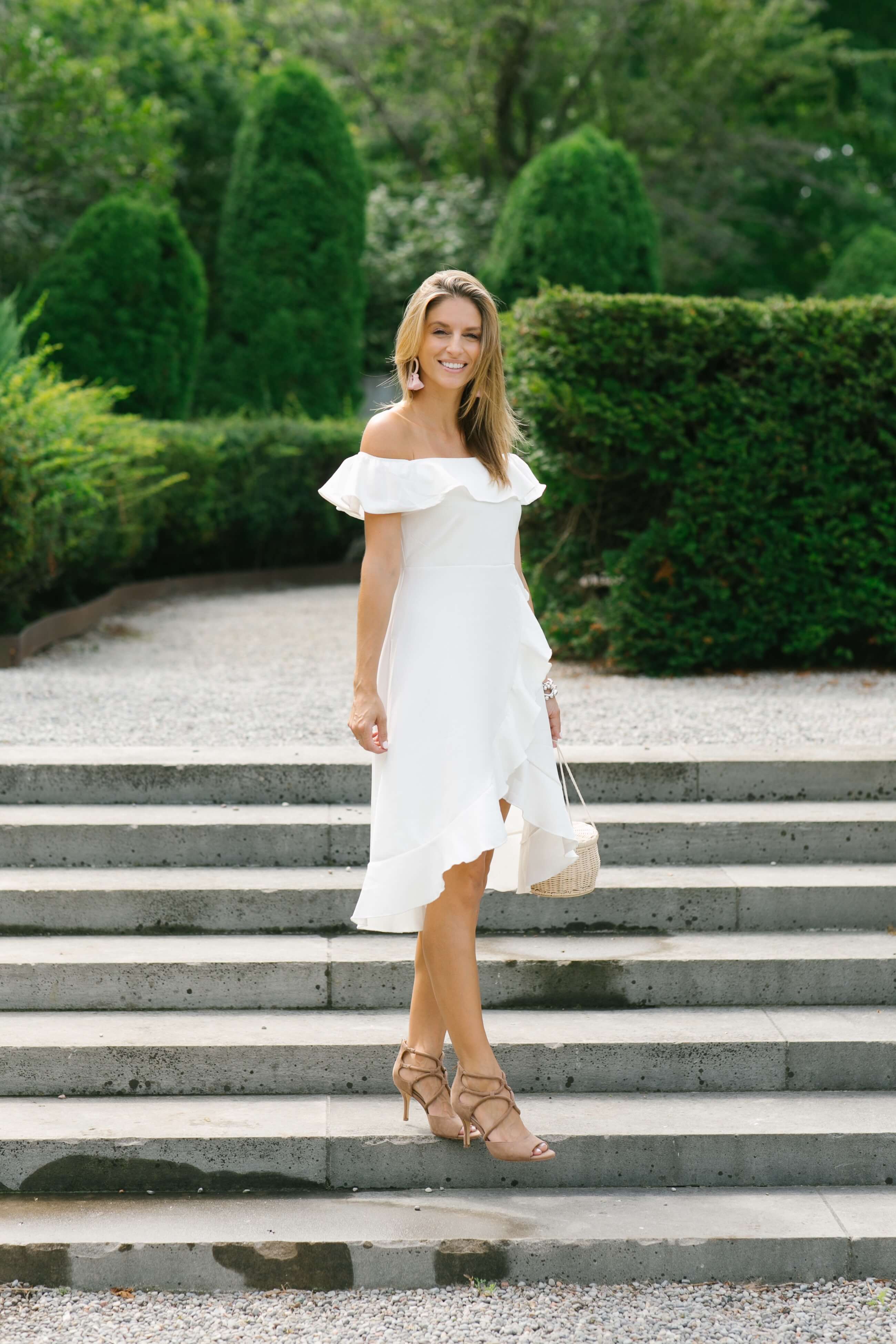 White off the shoulder ruffled dress, wicker basket bag; style for a wedding; pretty white dress; whitby blogger